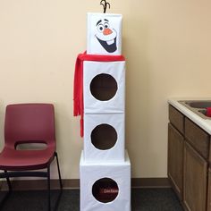 a tall tower made to look like a snowman with two holes in the middle