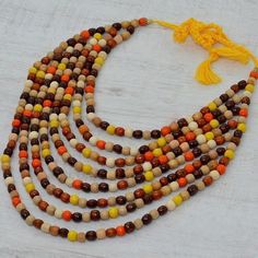 Handmade wooden necklace. Bead length: 0.5 cm. Material: natural wood, thread. Color: white, yellow, brown. The length of the necklace is 50 cm. A wooden necklace has occupied a special place at all times, which is why even now this decoration is more trendy than ever, able to be successfully combined with any style trends. Before you is one of the most charming models, which, despite the simplicity of the materials, can effectively decorate and make both business and everyday looks more perfect. The decoration is created by hand, thanks to which it has an impeccable appearance, has a special charm and energy of natural wood. Wooden beads are made in one size, their diameter is 0.5 cm. The decoration is easy to put on, as the beads are strung on a strong thread. Natural Wood Necklaces With Wooden Beads, Wooden Bead Necklace, Necklace Wood, Wooden Bead Necklaces, Necklace Bead, Wood Bead Necklace, Wooden Necklace, Wood Necklace, Style Trends