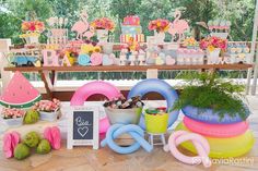 a table filled with lots of different types of food and decorations on top of it