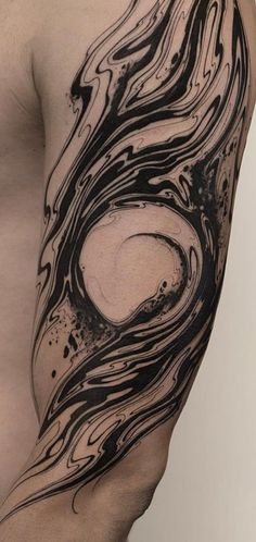 a man's arm with black and white swirls on the top of it