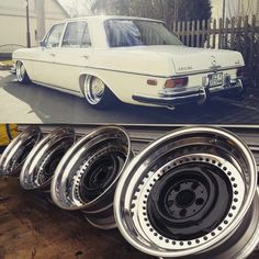 an old white car is parked in front of some rims