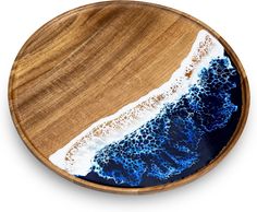 a wooden plate with blue and white waves on it