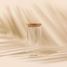 a clear glass jar with a wooden lid