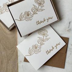 three thank you cards in a box with gold foil flowers on the front and back