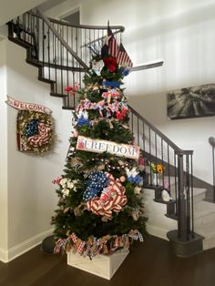 a christmas tree decorated with american flags and ribbons