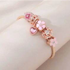 LOVCIA Pink Floral Daisy Love Fashion Bracelet for Women Enhance your jewelry collection with the LOVCIA Pink Floral Daisy Love Fashion Bracelet. This elegant bracelet features a blend of pink floral daisy charms, a heart charm, and sparkling crystals, making it a perfect accessory for any occasion. Crafted with high-quality materials and a stylish snake chain, it offers both beauty and durability. Key Highlights Beautiful pink floral daisy and heart charms with sparkling crystals High-quality copper alloy with gold plating for a luxurious look Adjustable length for a perfect fit on any wrist size Secure lobster claw clasp for easy wear and removal Elegant snake chain design for a sophisticated style Why You Should Buy This Bracelet Perfect gift for women who love elegant and trendy jewelr Elegant Pink Bracelet With Heart Charm, Adjustable Flower-shaped Bracelets With Charms, Adjustable Flower-shaped Charm Bracelets, Adjustable Flower Charms Bracelets, Pink Charms For Valentine's Day, Pink Metal Bangle Jewelry, Pink Heart Charm For Mother's Day, Pink Metal Beaded Bracelet With Charms, Pink Beaded Bracelets With Charms For Valentine's Day