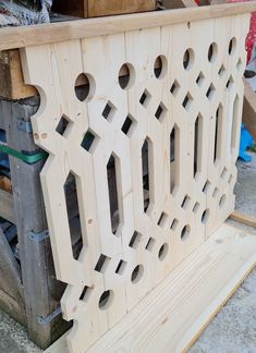 an unfinished bench made out of wood with holes in the top and side panels on each side