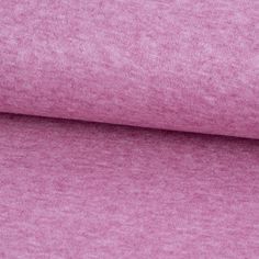 a close up shot of the pink fabric for a t - shirt or sweatering