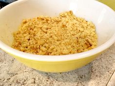 a yellow bowl filled with crumbs on top of a counter