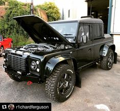 a black land rover with its hood open