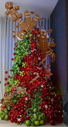 a christmas tree decorated with gingerbreads and other holiday decorations