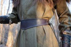 "Join the FOTW Realm and get an instant 10% off code! http://eepurl.com/hrobtv Beautiful leather belt, with simple yet elegant lines its shape comes to a small point in front and back, accenting the natural waist. Sides are adjustable with leather laces through antique brass grommets. Made with high quality dark chocolate brown cowhide, edges machine sewn. Width at widest point is 3\"-3 1/2\" depending on size. Sizes: (pictures show size S at 28\") XS - fits waist 25\"-29\" S - fits 28\"-33\" M Viking Hood, Leather Corset Belt, Medieval Belt, Medieval Garb, Medieval Woman, Leather Waist Belt, Brown Cowhide, Medieval Costume, Clothing Pieces