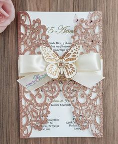 a pink and white wedding card with a butterfly on it