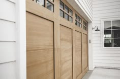 a wooden garage door on the side of a house