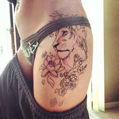 a woman with a lion tattoo on her stomach and some flowers around her waist,