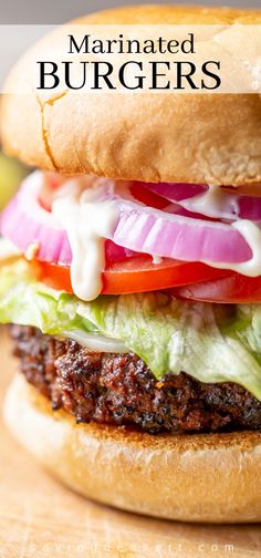 a hamburger with lettuce, tomato and onion on it