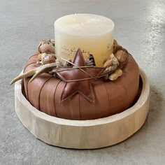 a candle sitting on top of a wooden stand with shells and other items around it