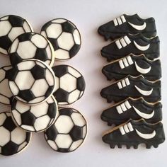 cookies decorated with black and white soccer balls are on a table next to each other