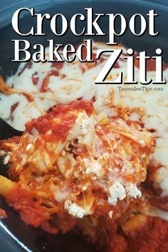 the crockpot baked ziti is in a black bowl with a spoon full of cheese and sauce