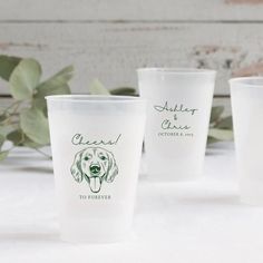 three plastic cups with the names of two dogs on them, one is white and the other is green