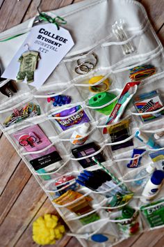 an organized drawer filled with lots of crafting supplies on a wooden floor next to scissors and other items