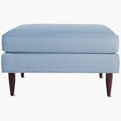 a blue footstool sitting on top of a white floor