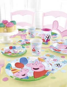 peppa pig birthday party supplies including plates, cups and cupcakes on a table