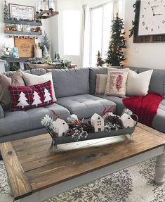 a living room filled with furniture and christmas decorations on top of a wooden coffee table