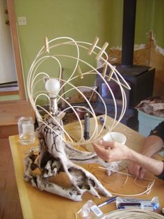 a man is working on a sculpture in his living room