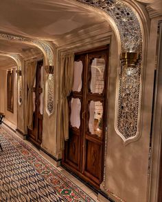 an ornately decorated hallway with wooden doors