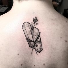 the back of a woman's neck with a tattoo on it that has two wrapped presents