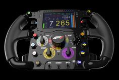 the steering wheel and dashboard of a race car on a black background with colorful buttons