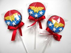 three lollipops wrapped in cellophane and decorated with the symbol of wonder