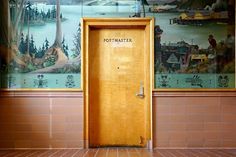 an open yellow door in front of a mural