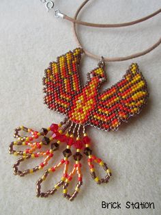 a beaded necklace with a bird on it