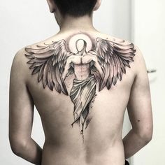 the back of a man with an angel tattoo on his upper and lower back tattoos