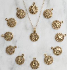 "Gold Zodiac Necklace, Zodiac Coin Necklace, gold constellation Necklace, Dainty Zodiac Necklace, Delicate Medallion Horoscope Necklace for layering This necklace features a dainty little antique gold plated zodiac charm suspended from a gold filled chain. The charm is crafted from vintage dies that date back to the 1950's. Lots of cool detail. The charm is brass that is gold plated and lightly antiqued to give it the look of an antique medallion. The chain is gold filled which is a great option Gold Zodiac Sign Pendant Charm Necklace, Gold Celestial Charm Necklace With Zodiac Sign, Celestial Style Gold Charm Necklace With Zodiac Sign, Gold Celestial Zodiac Sign Charm Necklace, Celestial Style Gold Zodiac Sign Charm Necklace, Ancient Coin Pendant, Coin Necklace Gold, Antique Medallion, Constellation Jewelry