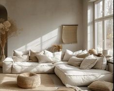 a living room filled with lots of white furniture