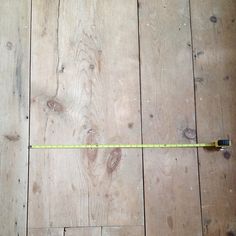 a wooden floor with a measuring tape on it