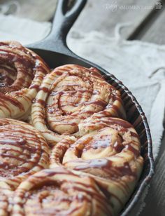 some cinnamon rolls are in a pan on the table