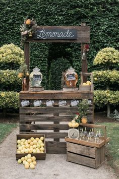 an outdoor lemonade stand with wooden crates filled with lemons