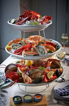 three tiered trays filled with different types of seafood