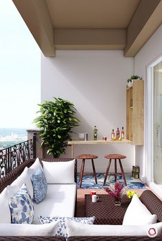 a living room with couches and tables on top of the floor next to a balcony