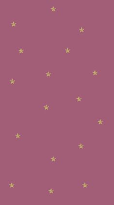 a pink wallpaper with gold stars on the top and bottom half, in various sizes