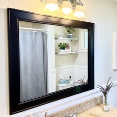 a bathroom with a sink, mirror and shelf in it's centerpieces