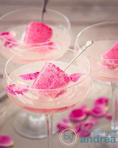 three glasses filled with pink desserts on top of a table