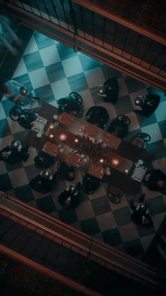 an overhead view of a table and chairs in a room with checkered flooring