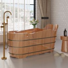 a wooden bath tub sitting next to a window