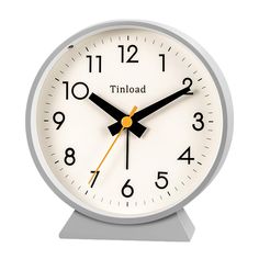 a white clock with black hands and numbers on the face is shown in front of a white background