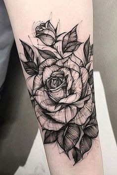 a black and white rose tattoo on the right arm, with leaves around it's petals